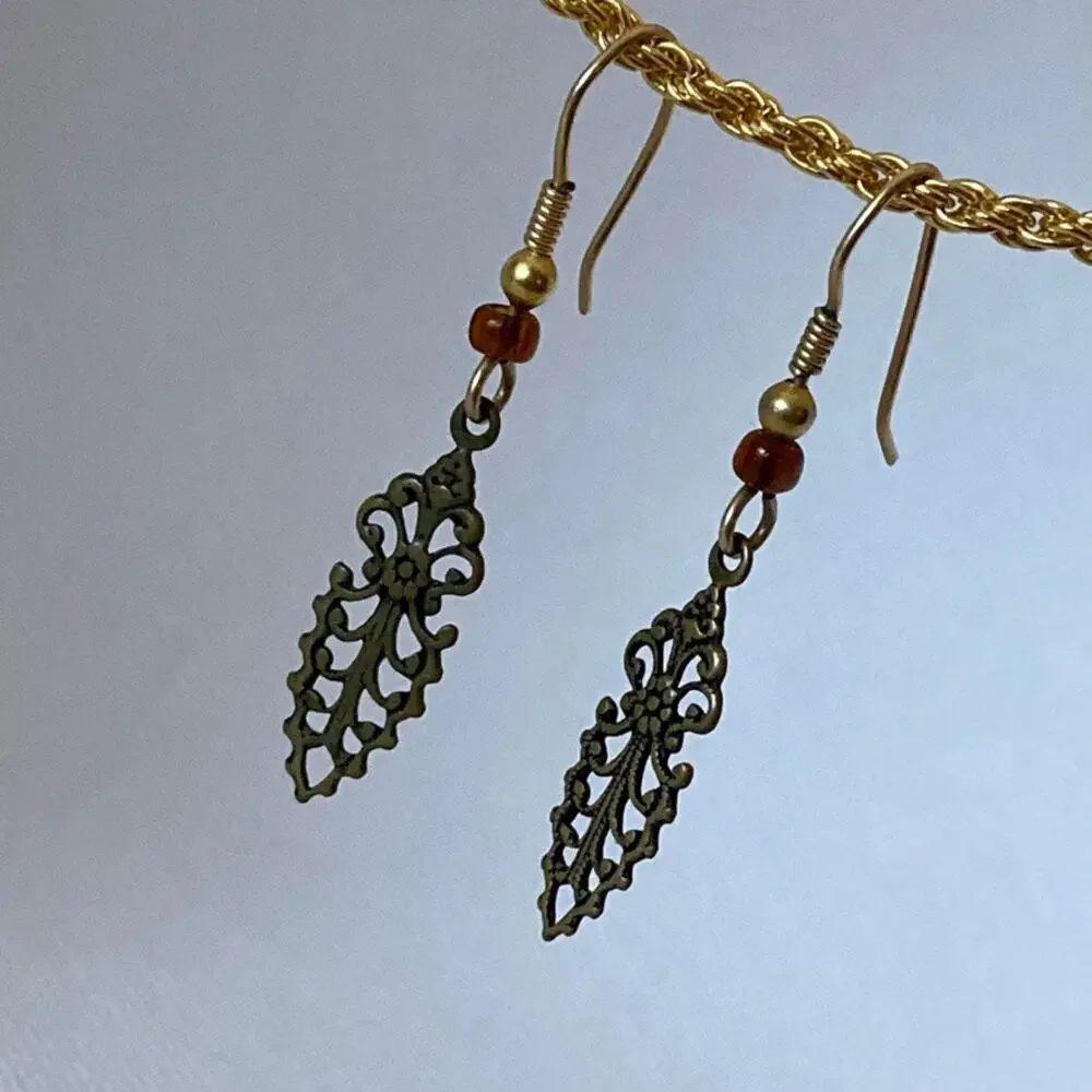 Brass tone ornate scroll/feather fish hook earrings